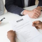 African-american applicant holding resume at job interview, clos