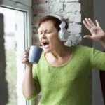 senior-woman-singing-coffee-cup